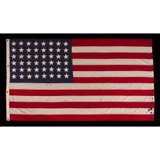 ANTIQUE AMERICAN FLAG WITH 48 STARS, A U.S. NAVY SMALL BOAT ENSIGN, MADE DURING WWII, IN DECEMBER OF 1943, AT MARE ISLAND, CALIFORNIA, HEADQUARTERS OF THE PACIFIC FLEET, SIGNED & DATED