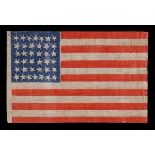38 STAR ANTIQUE AMERICAN FLAG WITH SCATTERED STAR POSITIONING ON A BILLIANT, BLUE CANTON, MADE DURING THE PERIOD WHEN COLORADO WAS THE MOST RECENT STATE TO JOIN THE UNION, 1876-1889