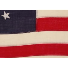 13 STARS IN THE BETSY ROSS PATTERN, ON A WOOL, ANTIQUE AMERICAN FLAG OF THE HIGHEST QUALITY OF THE TIME, MADE FOR THE D.A.R. IN THE PERIOD BETWEEN APPROX. 1905 AND 1926, POSSIBLY FOR THE SESQUCENTENNIAL OF AMERICAN INDEPEMNDENCE
