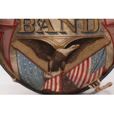 PATRIOTIC, PAINT-DECORATED BASE DRUM, WITH EXTRAORDINARY COLOR AND BOLD IMAGERY THAT INCLUDES AN EAGLE AND CROSSED FLAGS; FROM THE GENESEO CORONET BAND [LATER C.C.G. CORONET BAND], ACTIVE AT LEAST 1862 – 1901