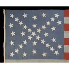 38 STAR ANTIQUE AMERICAN FLAG WITH A STARBURST CROSS ARRANGEMENT ON A PRUSSIAN BLUE CANTON, ONE OF THE MOST DYNAMIC CONFIGURATIONS THAT EXISTS IN FLAG COLLECTING, COLORADO STATEHOOD, 1876-1889