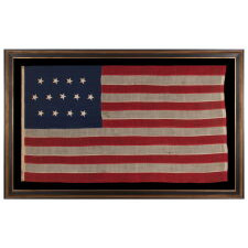 ENTIRELY HAND-SEWN, 13 STAR, ANTIQUE AMERICAN FLAG WITH A 4-5-4 PATTERN, PROBABLY A U.S. NAVY SMALL BOAT ENSIGN, WITH THE CURIOUS INSCRIPTION OF “GETTYSBURG” ALONG THE HOIST, MADE SOMETIME BETWEEN THE 1850’s AND THE OPENING YEARS OF THE CIVIL WAR, circa 1854-1863