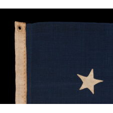 ENTIRELY HAND-SEWN, 13 STAR, ANTIQUE AMERICAN FLAG WITH A 4-5-4 PATTERN, PROBABLY A U.S. NAVY SMALL BOAT ENSIGN, WITH THE CURIOUS INSCRIPTION OF “GETTYSBURG” ALONG THE HOIST, MADE SOMETIME BETWEEN THE 1850’s AND THE OPENING YEARS OF THE CIVIL WAR, circa 1854-1863