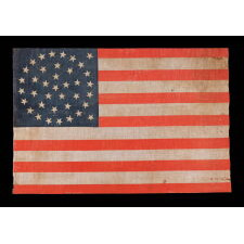 38 STARS IN A TRIPLE WREATH STYLE MEDALLION CONFIGURATION, WITH 2 OUTLIERS, ON A LARGE SCALE ANTIQUE AMERICAN PARADE FLAG WITH GREAT COLORS AND PRESENCE, MADE IN THE ERA WHEN COLORADO WAS THE MOST RECENT STATE TO JOIN THE UNION, 1876-1889
