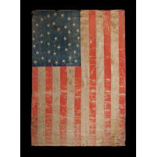 38 STAR ANTIQUE AMERICAN FLAG WITH AN EXCEPTIONALLY RARE “GREAT-STAR-IN-A-WREATH” CONFIGURATION AND ENDEARING WEAR FROM OBVIOUS LONG-TERM USE, 1876-1889, REFLECTS THE ADDITION OF COLORADO TO THE UNION