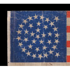 38 STAR ANTIQUE AMERICAN FLAG WITH AN OFF-BALANCE MEDALLION CONFIGURATION, ON A BRILLIANT BLUE CANTON, MADE IN THE PERIOD WHEN COLORADO WAS THE MOST RECENT STATE TO JOIN THE UNION, 1876-1889