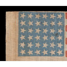 36 STAR ANTIQUE AMERICAN PARADE FLAG WITH CANTED STARS IN DANCING ROWS, ON A BEAUTIFUL, CORNFLOWER BLUE CANTON; CIVIL WAR ERA, NEVADA STATEHOOD, 1864-1867