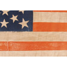31 STARS ON AN ANTIQUE AMERICAN FLAG OF THE PRE-CIVIL WAR ERA, WITH A DOUBLE-WREATH STYLE MEDALLION CONFIGURATION THAT FEATURES A LARGE, HALOED CENTER STAR; REFLECTS THE PERIOD WHEN CALIFORNIA WAS THE MOST RECENT STATE TO JOIN THE UNION, 1850-1858