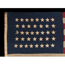 38 STAR ANTIQUE AMERICAN FLAG WITH HAND-SEWN STARS IN AN 8-7-8-7-8 PATTERN OF JUSTIFIED ROWS, MADE IN THE PERIOD WHEN COLORADO WAS THE MOST RECENT STATE TO JOIN THE UNION, 1876-1889