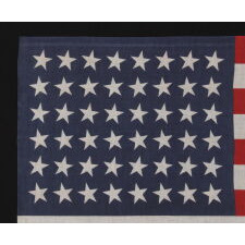 48 STAR FLAG WITH STARS CANTED TO THE RIGHT AND LEFT IN DANCING ROWS, A RARE VARIETY OF ANTIQUE AMERICAN PARADE FLAG IN A LARGE SCALE, 1912-1918 OR PERHAPS EARLIER, REFLECTS ARIZONA & NEW MEXICO STATEHOOD