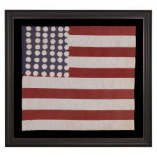 EXTRAORDINARY WWII LIBERATION FLAG WITH 48 SAWTOOTH STARS, THEIR NUMBER OF POINTS VARYING FROM 11 TO 16, AND A COMPLEMENT OF 10 STRIPES; MADE TO WELCOME U.S. TROOPS IN FRANCE IN 1944, FOLLOWING LIBERATION FROM THE GERMANS; AMONG THE BEST OF ITS KIND KNOWN TO EXIST; FOUND IN A PARIS ATTIC