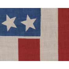 39 STARS IN TWO SIZES, ALTERNATING FROM ONE COLUMN TO THE NEXT, ON AN ANTIQUE AMERICAN PARADE FLAG DATING TO THE 1876 CENTENNIAL, NEVER AN OFFICIAL STAR COUNT, REFLECTS THE ANTICIPATED ARRIVAL OF COLORADO AND THE DAKOTA TERRITORY