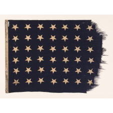48 STAR U.S. NAVY JACK, MARKED AS HAVING BEEN FLOWN ON THE U.S.S. FT. MANDAN, LAUNCHED NEAR THE END OF WWII, IN 1945, WITH SERVICE DURING BOTH THE KOREAN AND VIETNAM WAR ERAS, IN THE ARCTIC, AT THE NORTH POLE, AND AT GUANTANAMO BAY DURING THE CUBAN MISSILE CRISIS; FLOWN DURING THE EARLIEST POINT OF THE SHIP’S SERVICE, THE FLAG EXHIBITS ENDEARING WEAR FROM OBVIOUS USE