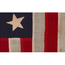 13 STARS IN A 3-2-3-2-3 PATTERN ON AN ANTIQUE AMERICAN FLAG, A UNITED STATES NAVY SMALL BOAT ENSIGN, MADE AT THE BROOKLYN NAVY YARD, NEW YORK, SIGNED & DATED 1898