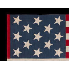 13 STAR ANTIQUE AMERICAN PARADE FLAG, WITH A 3-2-3-2-3 CONFIGURATION OF STARS, AN EXTREMELY SCARCE AND UNUSUALLY LARGE VARIETY, MADE circa 1876-1899