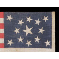 13 STARS IN A MEDALLION PATTERN ON AN ANTIQUE AMERICAN PARADE FLAG MADE FOR THE 1876 CENTENNIAL OF AMERICAN INDEPENDENCE, IN AN UNUSUALLY LARGE SIZE AMONG ITS COUNTERPARTS