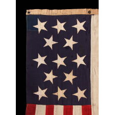 13 HAND-SEWN STARS IN A 3-2-3-2-3 PATTERN ON AN ANTIQUE AMERICAN FLAG, A U.S. NAVY SMALL BOAT ENSIGN MADE AT MARE ISLAND, CALIFORNIA, HEADQUARTERS OF THE PACIFIC FLEET, SIGNED & DATED 1902