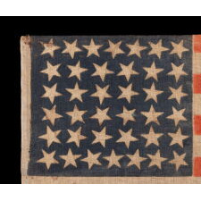 38 STAR ANTIQUE AMERICAN PARADE FLAG WITH JUSTIFIED ROWS OF 7-6-6-6-6-7 AND SCATTERED STAR ORIENTATION, MADE DURING THE PERIOD WHEN COLORADO WAS THE MOST RECENT STATE TO JOIN THE UNION, 1876-1889