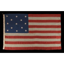 13 STAR ANTIQUE AMERICAN FLAG, MADE BETWEEN THE 1876 CENTENNIAL AND THE LAST DECADE OF THE 19TH CENTURY, WITH A 3-2-3-2-3 CONFIGURATION AND IN AN UNUSUALLY LARGE SCALE FOR THE TIME PERIOD AMONG FLAGS IN THIS STAR COUNT
