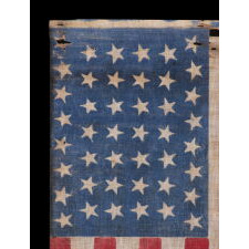 44 TUMBLING STARS IN AN HOURGLASS PATTERN, ON AN ANTIQUE AMERICAN FLAG WITH A STRIKING, BRIGHT BLUE CANTON AND SCARLET STRIPES, REFLECTS WYOMING STATEHOOD, circa 1890-1896