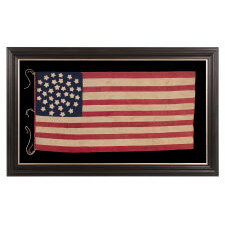 34 STAR ANTIQUE AMERICAN FLAG OF THE CIVIL WAR PERIOD (1861-63), IN A TINY SCALE AMONG PIECED-AND-SEWN FLAGS OF THE PERIOD, WITH A TRIPLE-WREATH CONFIGURATION, AN ELONGATED FORMAT, AND ENTIRELY HAND-SEWN; FOUND WITH A LETTER FROM JOHN W. RUDE OF THE 2ND KENTUCKY VETERAN VOLUNTEER CAVALRY (UNION)