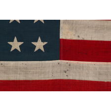 38 STAR ANTIQUE AMERICAN FLAG WITH A NOTCHED CONFIGURATION, MADE BY THE U.S. BUNTING COMPANY IN LOWELL, MASSACHUSETTS, REFLECTS THE ERA OF COLORADO STATEHOOD, circa 1876-1889