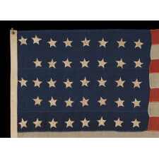38 HAND-SEWN STARS IN A "NOTCHED" PATTERN ON AN ANTIQUE AMERICAN FLAG MADE AT THE TIME WHEN COLORADO WAS THE MOST RECENT STATE TO JOIN THE UNION, 1876-1889