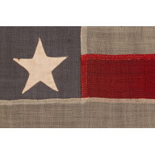 13 STAR ANTIQUE AMERICAN FLAG WITH A DUSTY BLUE CANTON, MADE IN THE ERA OF THE 1876 CENTENNIAL, IN AN INTERESTING CONFIGURATION THAT FEATURES TRIOS OF STARS IN EACH CORNER AND A SINGLE, CENTER STAR; A RARE VARIANT THAT I CLASSIFY “TRI-CORNER HAT” MEDALLION