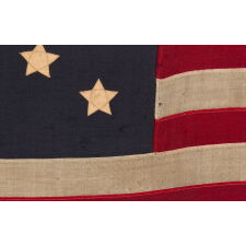 13 STARS WITH SHORT, CONICAL ARMS ON A SMALL SCALE, ANTIQUE AMERICAN FLAG MADE DURING THE LAST DECADE F THE 19TH CENTURY; POSSIBLY OF PHILADELPHIA ORIGIN; FORMERLY IN THE COLLECTION OF BOLESLAW & MARIE D'OTRANGE MASTAI, THE FIRST MAJOR COLLECTORS TO PUBLISH A PICTORIAL REFERENCE (KNOPF, NEW YORK, 1973):