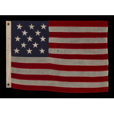 13 STAR ANTIQUE AMERICAN FLAG WITH A 3-2-3-2-3 CONFIGURATION OF STARS ON AN INDIGO CANTON, SQUARISH PROPORTIONS, AND A BEAUTIFUL OVERALL PRESENTATION, MADE circa 1895-1926
