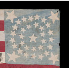 ONE OF THE TWO BEST OF ALL KNOWN FLAGS ADVERTISING ABRAHAM LINCOLN’S 1864 INCUMBENT PRESIDENTIAL CAMPAIGN FOR THE WHITE HOUSE, WITH VICE PRESIDENTIAL RUNNING MATE ANDREW JOHNSON; ENTIRELY HAND-SEWN, WITH A DOUBLE-WREATH CONFIGURATION OF 34 STARS, IN THREE DIFFERENT SIZES, THAT FEATURES HUGE STARS IN EACH CORNER, WITH 9 STRIPES AND WITH ITS CANTON RESTING ON THE WAR STRIPE, BOLD LETTERING , AND IN AN IDEAL SCALE AMONG ALL FLAGS OF THIS ERA