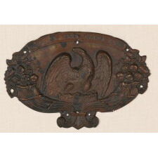 ESPECIALLY LARGE EARLY AMERICAN MILITARY HAT PLATE, MADE OF PRESSED COPPER, WITH AN EAGLE PERCHED ON A FEDERAL SHIELD, FLANKED BY CORNUCOPIA, AND THE MOTTO “NE PLUS ULTRA” (THE ZENITH OR HIGH WATER MARK); PRESSED BRASS WITH PAINTED SURFACE, circa 1825-1850 OR POSSIBLY PRIOR