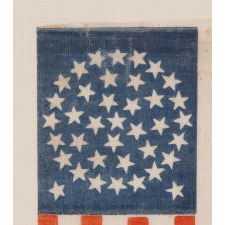 38 STARS IN A MEDALLION CONFIGURATION WITH 2 OUTLIERS, ON AN ANTIQUE AMERICAN FLAG WITH VIBRANT COLORATION, REFLECTS COLORADO STATEHOOD, 1876-1889, ILLUSTRATED IN “THE STARS & STRIPES: FABRIC OF THE AMERICAN SPIRIT” by RICHARD PIERCE, 2005