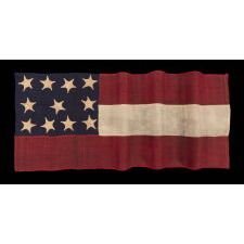 WAR-PERIOD CONFEDERATE FLAG IN THE FIRST NATIONAL PATTERN (a.k.a., STARS & BARS), IN A TINY SIZE, WITH AN ELONGATED PROFILE, AND 11 STARS ARRANGED IN AN UNUSUAL, RECTANGULAR MEDALLION; ENTIRELY HAND-SEWN, MADE BETWEEN MAY - NOVEMBER, 1861