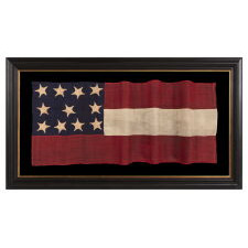 WAR-PERIOD CONFEDERATE FLAG IN THE FIRST NATIONAL PATTERN (a.k.a., STARS & BARS), IN A TINY SIZE, WITH AN ELONGATED PROFILE, AND 11 STARS ARRANGED IN AN UNUSUAL, RECTANGULAR MEDALLION; ENTIRELY HAND-SEWN, MADE BETWEEN MAY - NOVEMBER, 1861