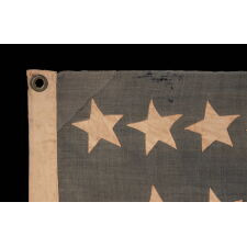38 STARS IN A "NOTCHED" PATTERN, ON AN ANTIQUE AMERICAN FLAG WITH A DUSTY BLUE CANTON; LEAVES SPACE FOR MORE WESTERN TERRITORIES THAT HAD NOT YET JOINED THE UNION; REFLECTS COLORADO STATEHOOD, 1876-1889