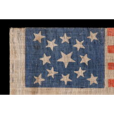 13 STARS IN A MEDALLION PATTERN ON AN ANTIQUE AMERICAN PARADE FLAG MADE SOMETIME BETWEEN THE CIVIL WAR (1861-1865) AND THE 1876 CENTENNIAL OF AMERICAN INDEPENDENCE, WITH A BEAUTIFUL, CORNFLOWER BLUE CANTON AND IN AN UNUSUALLY LARGE SIZE AMONG ITS COUNTERPARTS