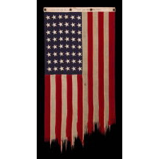 ANTIQUE AMERICAN FLAG WITH 48 STARS, A U.S. NAVY SMALL BOAT ENSIGN, MADE IN SEPTEMBER OF 1943, DURING WWII, AT MARE ISLAND, CALIFORNIA, HEADQUARTERS OF THE PACIFIC FLEET, WITH ENDEARING WEAR FROM OBVIOUS LONG-TERM USE
