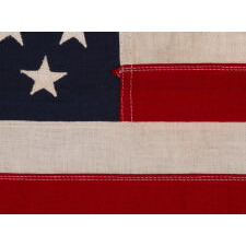 49 STAR AMERICAN FLAG IN A SMALL SCALE AMONG ITS COUNTERPARTS WITH PIECED AND SEWN CONSTRUCTION, REFLECTS THE ADDITION OF ALASKA IN 1959, OFFICIAL FOR JUST ONE YEAR; EXHIBITED JUNE-SEPTEMBER, 2021 AT THE MUSEUM OF THE AMERICAN REVOLUTION