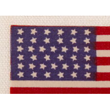 38 STAR AMERICAN FLAG RIBBON WITH JUSTIFIED ROWS OF CANTED STARS AND AN ATTRACTIVE, ELONGATED PROFILE, COLORADO STATEHOOD, 1876-1889