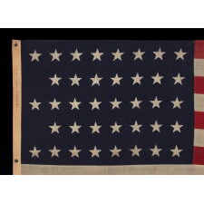 38 STAR ANTIQUE AMERICAN FLAG WITH A NOTCHED CONFIGURATION, MADE BY THE U.S. BUNTING COMPANY IN LOWELL, MASSACHUSETTS, REFLECTS THE ERA OF COLORADO STATEHOOD, circa 1876-1889