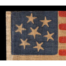 7 STARS WITH WHIMSICAL PROFILES ON AN ANTIQUE AMERICAN PARADE FLAG, MADE TO REFLECT THE INITIAL WAVE OF 7 STATES SECEDED FROM THE UNION, A CIVIL WAR PERIOD EXAMPLE, THE LARGEST OF SEVERAL KNOWN VARIETIES, MADE circa 1861