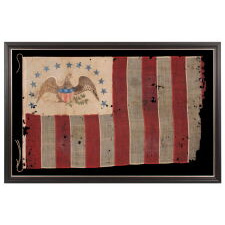 ONE OF THE TWO EARLIEST KNOWN EXAMPLES OF THE FLAG OF THE REVENUE MARINE (a.k.a., REVENUE CUTTER SERVICE), WITH A HAND-PAINTED EAGLE, AN ARCH OF 13 BLUE-PAINTED STARS, HAVING GREAT FOLK QUALITIES, AND 13 VERTICAL STRIPES, LATE 1830’s-1860