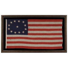 13 STAR ANTIQUE AMERICAN FLAG WITH AN OVAL VERSION OF WHAT IS KNOWN AS THE 3RD MARYLAND PATTERN, MADE IN THE PERIOD BETWEEN THE CIVIL WAR (1861-65) AND THE 1876 CENTENNIAL OF AMERICAN INDEPENDENCE