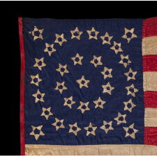 EXTRAORDINARY, HOMEMADE, 33 STAR ANTIQUE AMERICAN PARADE FLAG, AMONG ITS COUNTERPARTS, MADE OF SILK AND EXPERTLY HAND-SEWN THROUGHOUT, WITH UNUSUAL EMBROIDERED STARS IN A DOUBLE WREATH STYLE MEDALLION; LIKELY MADE FOR THE PRESIDENTIAL CAMPAIGN IN WHICH LINCOLN WON THE WHITE HOUSE; REFLECTS THE ADDITION OF OREGON IN 1859, OFFICIAL FROM THAT YEAR UNTIL 1861, PRE-CIVIL WAR THROUGH THE WAR’S OPENING YEAR