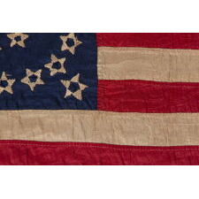 EXTRAORDINARY, HOMEMADE, 33 STAR ANTIQUE AMERICAN PARADE FLAG, AMONG ITS COUNTERPARTS, MADE OF SILK AND EXPERTLY HAND-SEWN THROUGHOUT, WITH UNUSUAL EMBROIDERED STARS IN A DOUBLE WREATH STYLE MEDALLION; LIKELY MADE FOR THE PRESIDENTIAL CAMPAIGN IN WHICH LINCOLN WON THE WHITE HOUSE; REFLECTS THE ADDITION OF OREGON IN 1859, OFFICIAL FROM THAT YEAR UNTIL 1861, PRE-CIVIL WAR THROUGH THE WAR’S OPENING YEAR