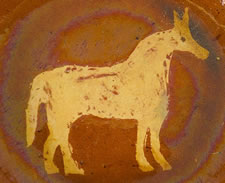 PENNSYLVANIA REDWARE PLATE BY MEDINGER, SLIP-DECORATED WITH RARE IMAGE OF A HORSE