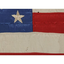 RARE & BEAUTIFUL 38 STAR ANTIQUE AMERICAN FLAG, AN INDIAN WAR PERIOD MILITARY GUIDON, MADE OF SILK AND ENTIRELY HAND-SEWN, WITH EMBROIDERED STARS IN A MEDALLION CONFIGURATION, 1876-1889, COLORADO STATEHOOD