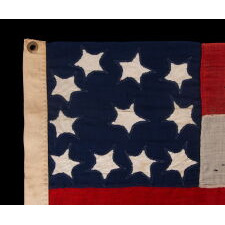 VERY RARE CONFEDERATE NAVAL ENSIGN IN THE FIRST NATIONAL (STARS & BARS) PATTERN, IN AN EXTRAORDINARY, SMALL SIZE, WITH 11 WHIMSICAL, SINGLE-APPLIQUÉD STARS AND A CURIOUSLY WIDE RED BAR, ENTIRELY HAND-SEWN, MADE BETWEEN MAY - NOVEMBER OF 1861: