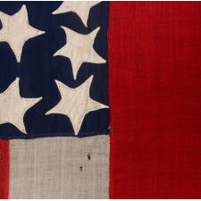 VERY RARE CONFEDERATE NAVAL ENSIGN IN THE FIRST NATIONAL (STARS & BARS) PATTERN, IN AN EXTRAORDINARY, SMALL SIZE, WITH 11 WHIMSICAL, SINGLE-APPLIQUÉD STARS AND A CURIOUSLY WIDE RED BAR, ENTIRELY HAND-SEWN, MADE BETWEEN MAY - NOVEMBER OF 1861: